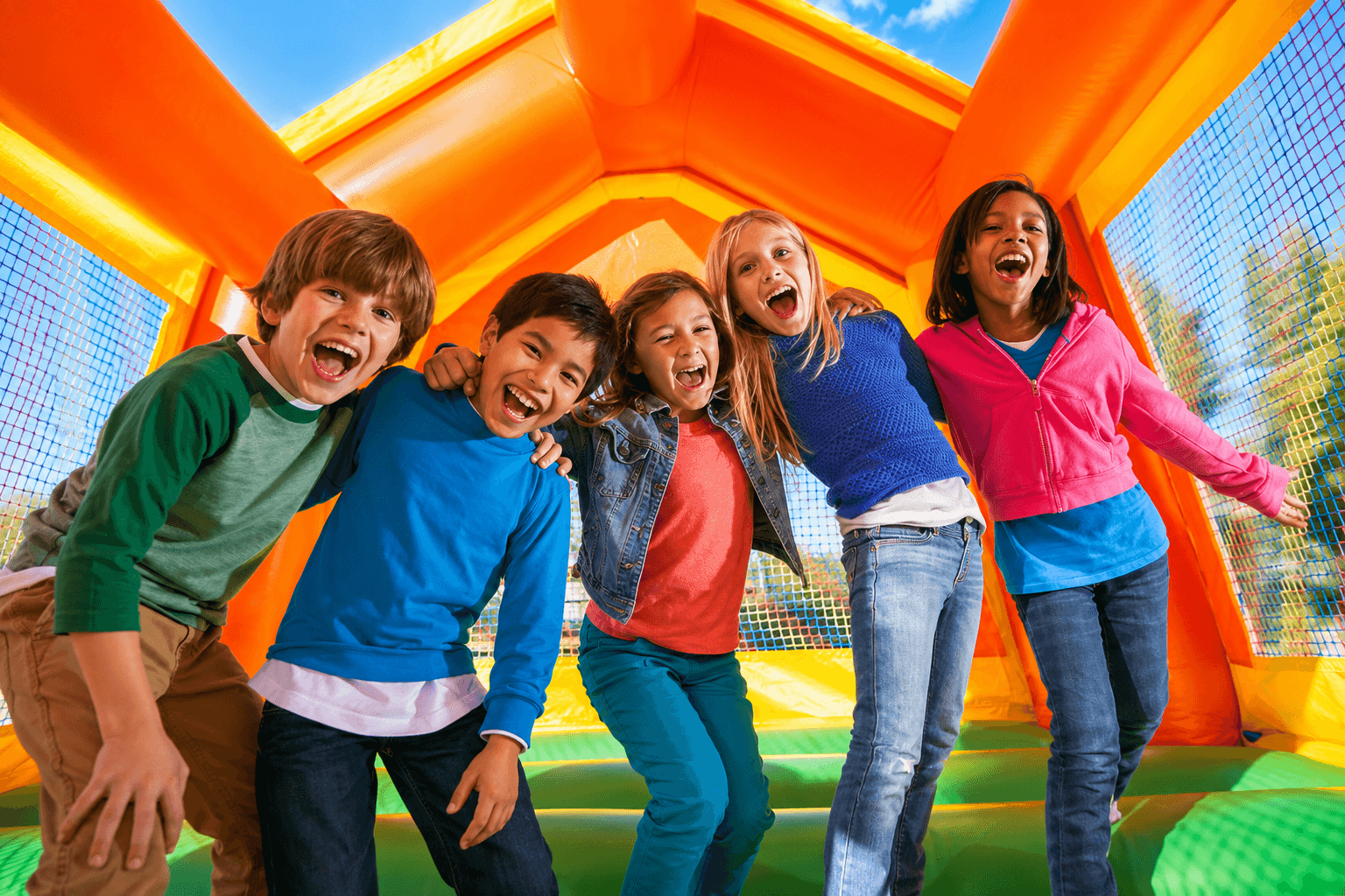 Happy kids at a bounce house party where digital waivers were completed before setup