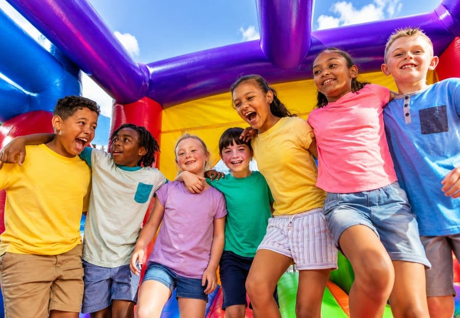 Large outdoor party with inflatable rentals that require delivery and setup